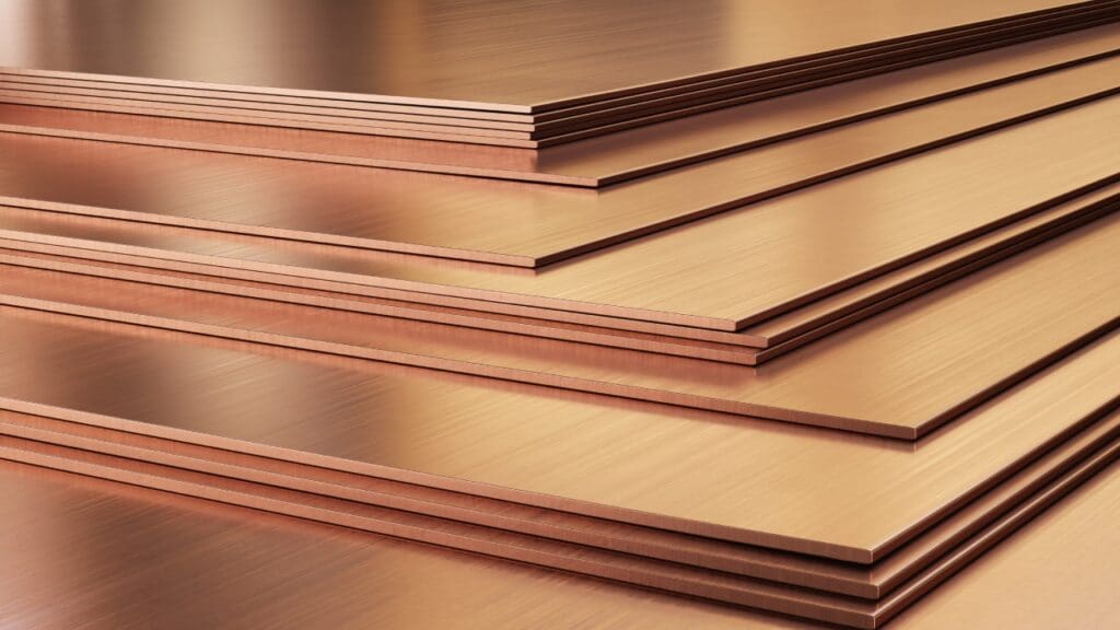 Stacked copper sheets, metallic texture.