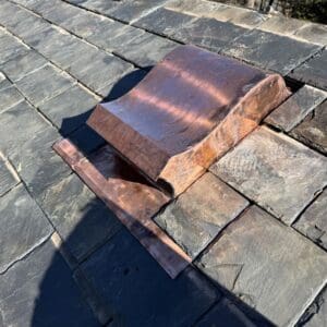 Copper vent on slate roof.