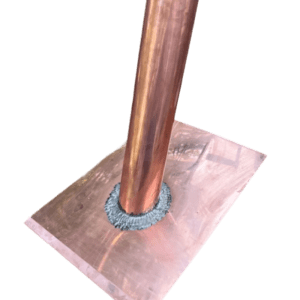 Copper pipe welded to a flat surface.