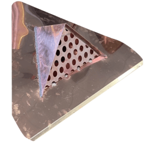 Triangular metal object with perforated surface.