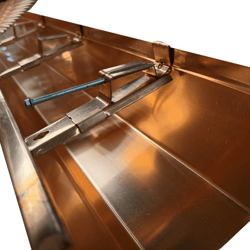 Copper rain gutter with leaf guard installed.